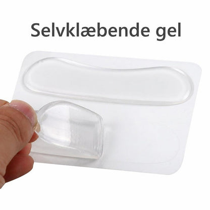 Gennemsigtige selvhæftende gel-hælindlæg på ark, hvor én pude løftes