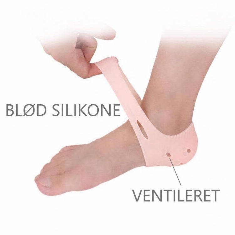 Lyserød silikone-hælbeskytter med ventilationshuller på en fod