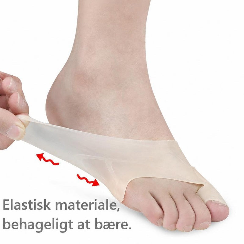 Gennemsigtigt silikone hallux valgus-støtte på fod, vist strakt ved anklen