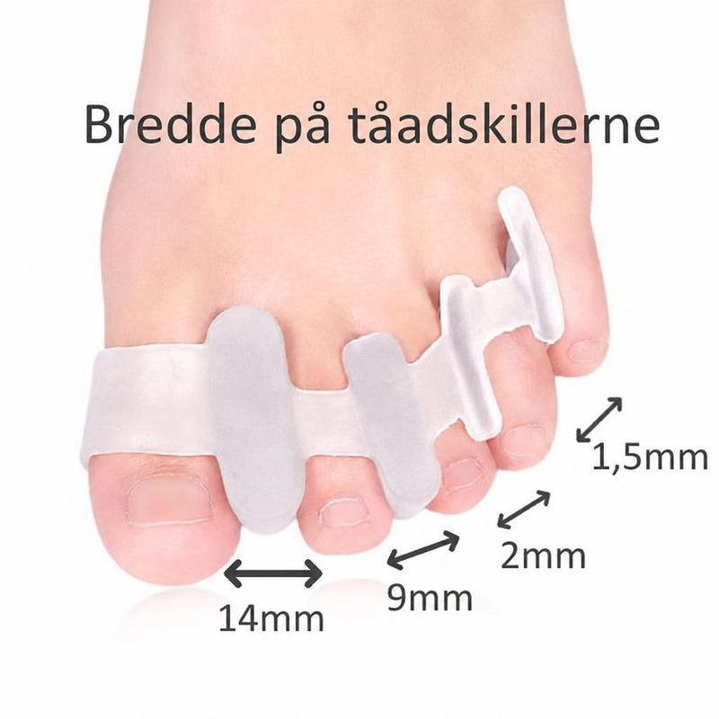 Hvid tåseparator på fod med afstandsmål mellem tæerne