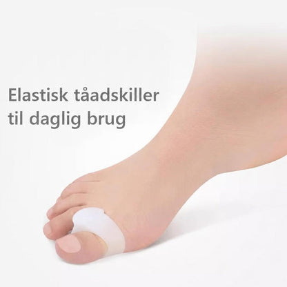 Fod med hvid silikone-tåseparator omkring storetåen