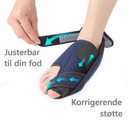 Blå hallux valgus støtteskinne i tekstil med justerbar rem på fod