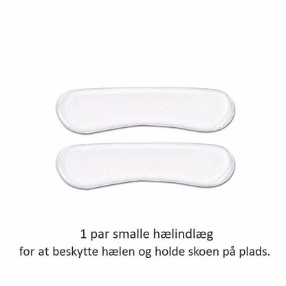 Et par smalle hvide hælindlæg i silikone på hvid baggrund