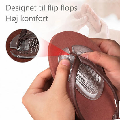 Selvklæbende silikone-forfodsindlæg monteres på brun flip-flop sandal