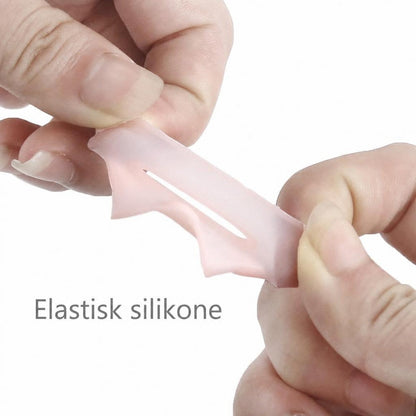 Elastisk lyserød silikonebeskytter til storetå strækkes mellem fingre