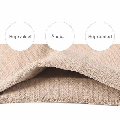 Beige elastisk knæstøtte i nærbillede med synlig stofstruktur