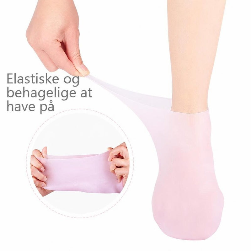 Lyserød gelstrømpe på fod, der strækkes for at vise elasticitet