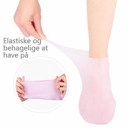 Lyserød gelstrømpe på fod, der strækkes for at vise elasticitet