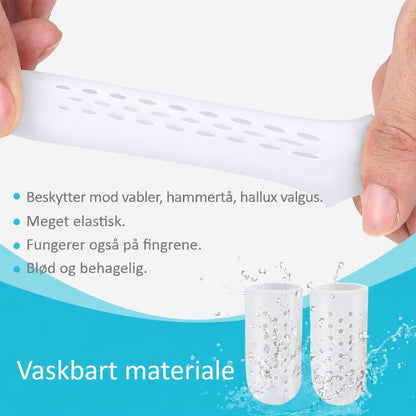 Hvid ventileret tåbeskytter i silikone strækkes mellem fingre