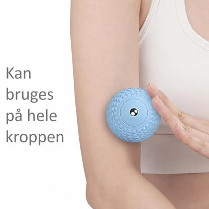 Blå tekstureret massagebold holdes mod overarmen