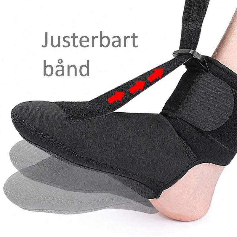 Sort natstrømpe på fod med justerbart bånd og røde pile