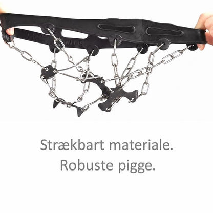 Sorte brodder med stålkæder og pigge holdt udstrakt mellem hænder