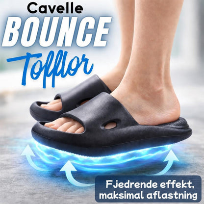 Fødder i sorte Cavelle Bounce-tøfler med brede remme og blå effekt