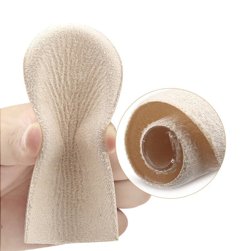 Beige hælindlæg med tekstiloverflade og lagdelt opbygning vist i hånden